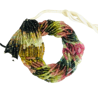 Multi-color natural gemstone bead strands, twisted together, with a white thread tie.