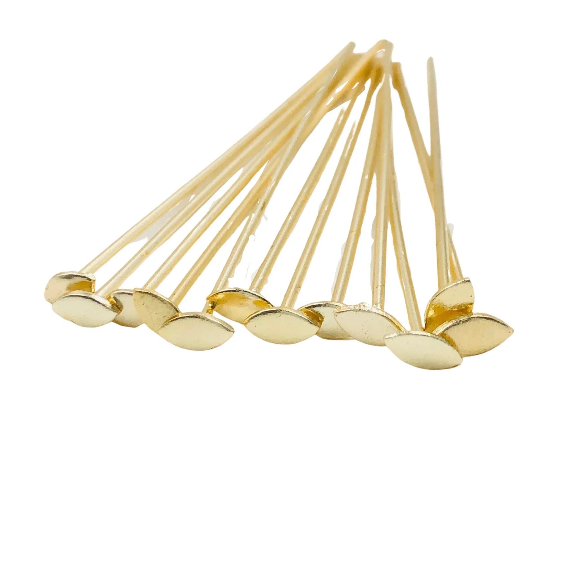 Gold marquise headpins for jewelry making, findings supplies on white background