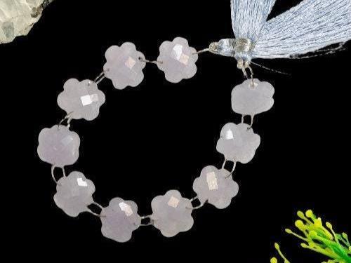 Faceted flower-shaped lavender gemstone beads strand on black background with tassel