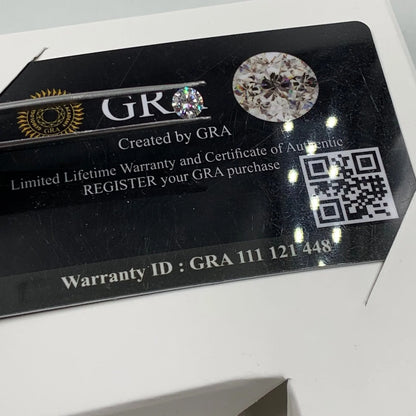 GRA authenticity card with loose gemstone, certificate details, QR code, and warranty ID.