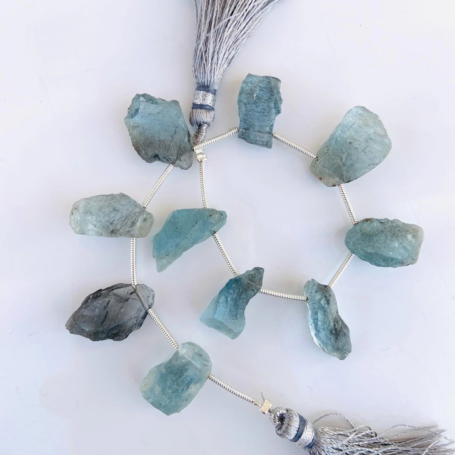 Raw aquamarine gemstone beads on string with silver tassels, natural crystal jewelry supplies