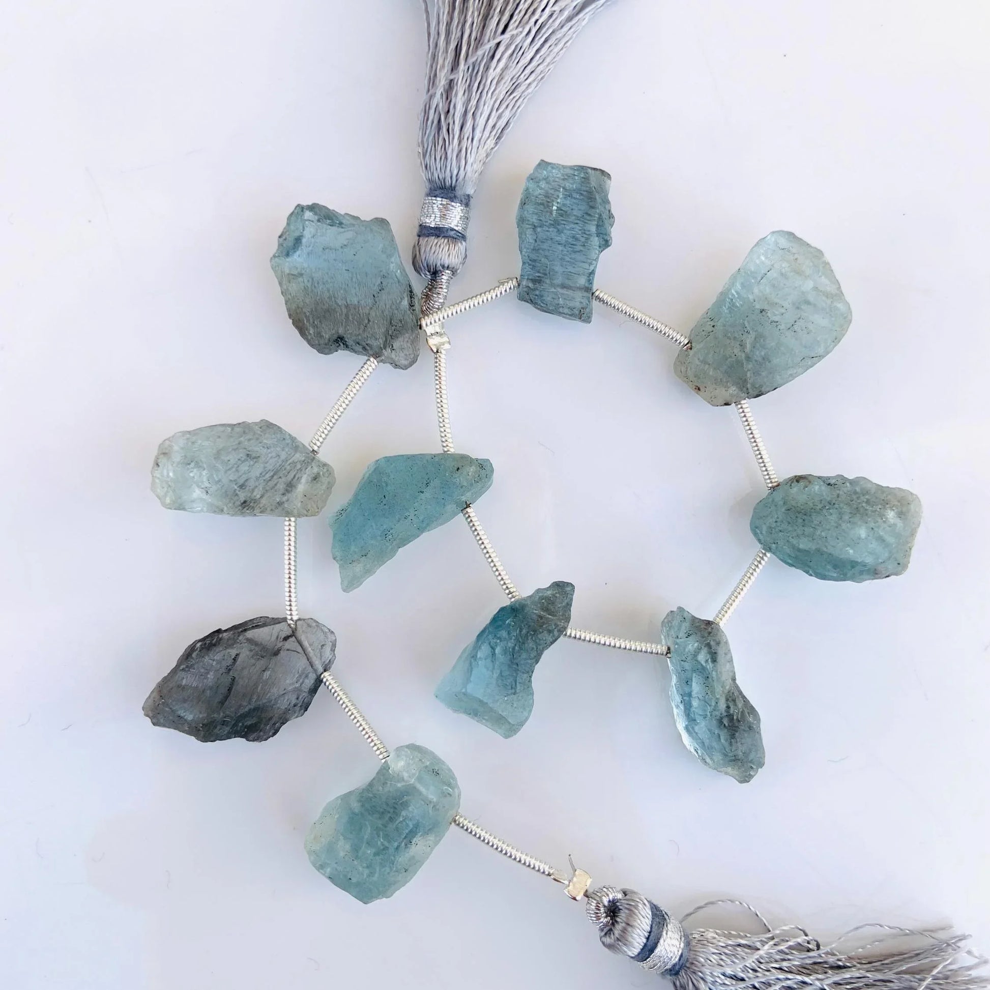 Raw aquamarine gemstone beads on string with silver tassels, natural crystal jewelry supplies