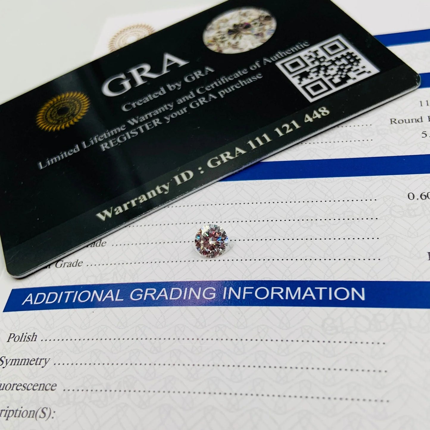 Round cut gemstone with grading certificate and warranty card