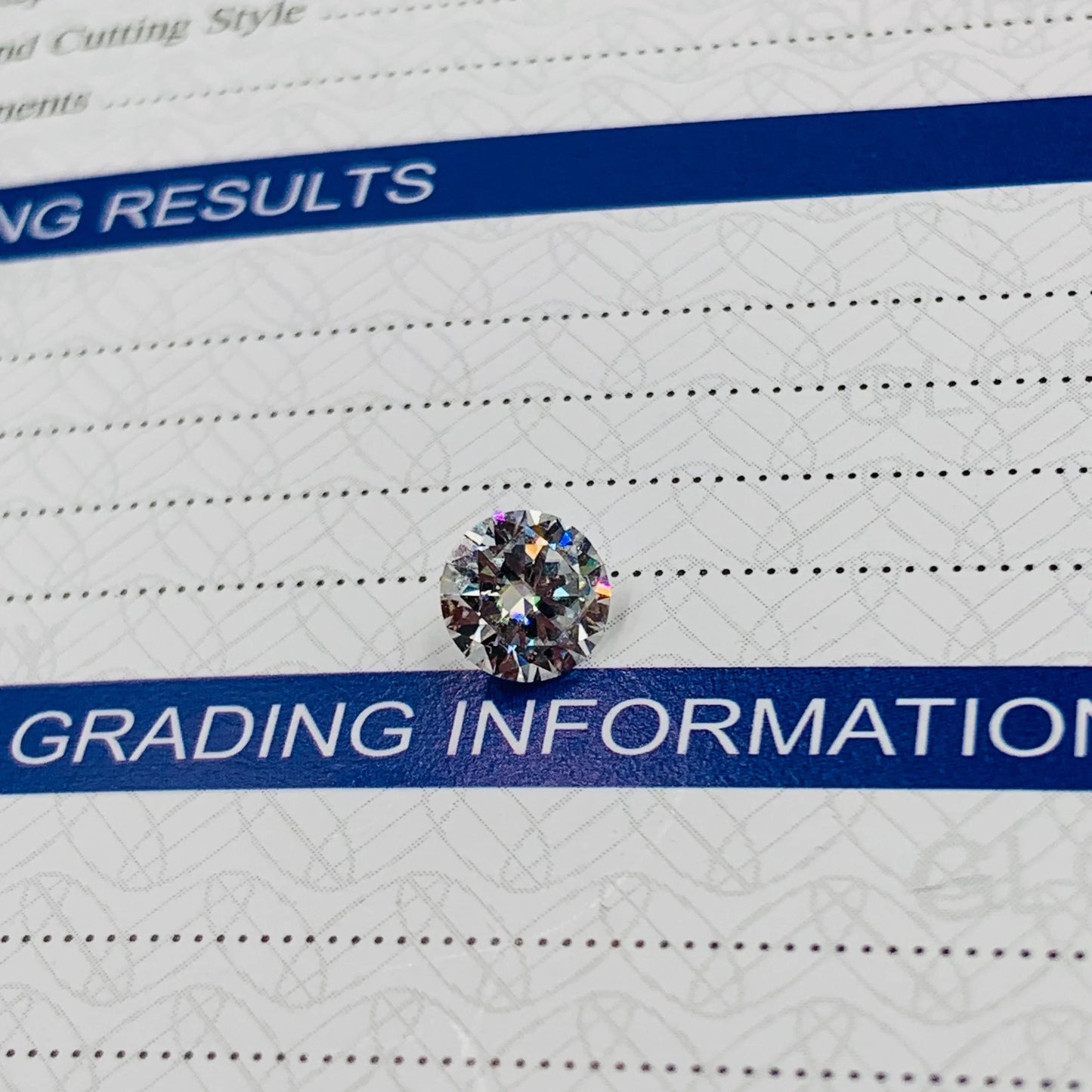 Loose round brilliant cut gemstone displayed on diamond grading report